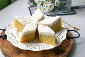 Kuih Talam Pisang, a steamed dessert made with banana and rice flour, featuring a soft, layered texture and sweet, creamy flavor.