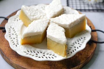 Kuih Talam Pisang, a steamed dessert made with banana and rice flour, featuring a soft, layered texture and sweet, creamy flavor.