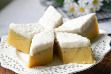 Kuih Talam Pisang, a steamed dessert made with banana and rice flour, featuring a soft, layered texture and sweet, creamy flavor.