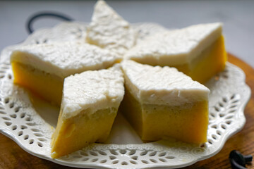 Kuih Talam Pisang, a steamed dessert made with banana and rice flour, featuring a soft, layered texture and sweet, creamy flavor.