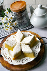 Kuih Talam Pisang, a steamed dessert made with banana and rice flour, featuring a soft, layered texture and sweet, creamy flavor.