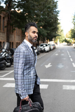 Businessman crossing road in street
