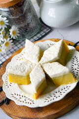 Kuih Talam Pisang, a steamed dessert made with banana and rice flour, featuring a soft, layered texture and sweet, creamy flavor.