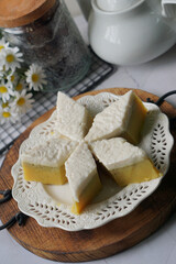 Kuih Talam Pisang, a steamed dessert made with banana and rice flour, featuring a soft, layered texture and sweet, creamy flavor.