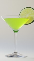 A classic martini glass filled with a bright yellow liquid and garnished with a lime wedge.