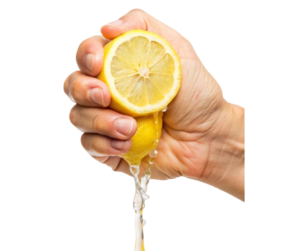 Hand squeezing lemon juice from a freshly cut lemon