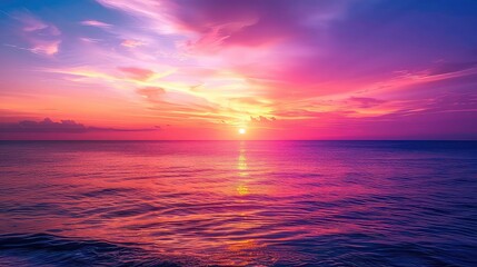 Obraz premium A stunning sunset over the ocean with rippling water and a vibrant sky.