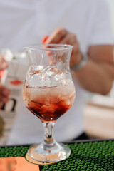 Refreshing cocktail in a stylish glass with ice and vibrant colors on a bar counter