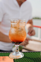 Refreshing Tropical Cocktail With Ice Served In Elegant Glass By The Waterfront