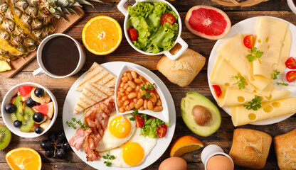 Top View of English Breakfast Assortment with Coffee, Eggs, Bacon, Cheese, and Fresh Fruits – Buffet Style