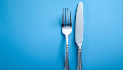 Fork and Knife on a Pastel Blue Background