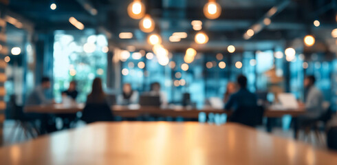 Obraz premium blurred office interior captures dynamic workspace with people collaborating and working together. warm lighting creates an inviting atmosphere, enhancing productivity and creativity