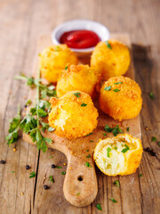 Crispy Fried Potato Balls on Wooden Board with Dipping Sauce – Delicious Snack