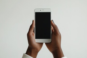 Hands holding smartphone with blank screen on white