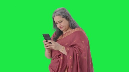 Angry Indian old woman chatting on phone Green screen