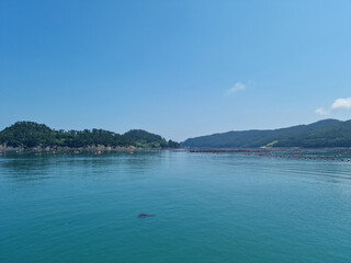 It is a landscape with an island and the sea.