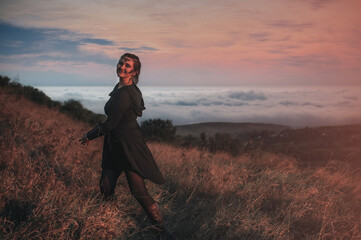 Beautiful girl in black gothic style clothes with tattoo on her face