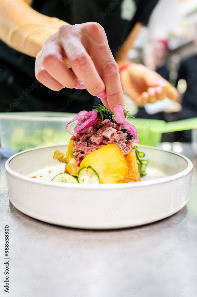 Poster a chef’s hand garnishing a colorful plated dish with fresh herbs, highlighting the final touch in me