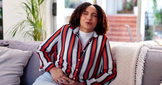 Stomach pain, emergency or woman in home with stress, pms or gut health, gas or ibs with colonoscopy. Abdomen, body risk and hurt girl in living room with indigestion, constipation or endometriosis