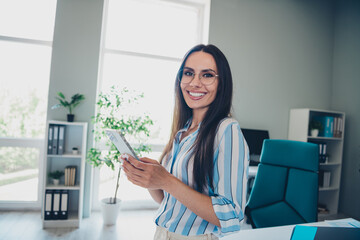 Photo of professional lovely lady hold device wear striped formalwear coworking successful businesswoman nice light office