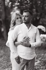 Romantic Couple Embracing in Nature Setting, Celebrating Engagement or Wedding in Black and White