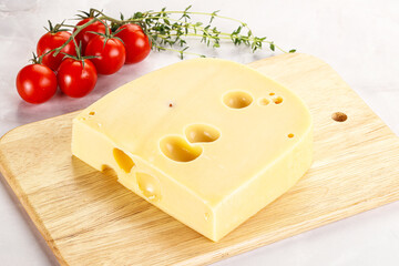 Maasdam cheese brick over board