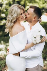 Romantic Couple Embracing Outdoors in a Lush Green Park on a Sunny Day