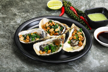 Open half oysters with green onion