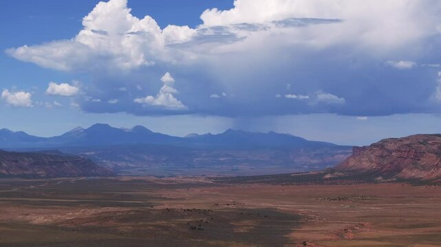 Colorado Utah Border aerial drone circle right motion Moab Spanish Valley La Sal Mountain Rocky Mountains road Telluride Montrose county summer dry Redvale Norwood rain thunderstorm clouds sunny