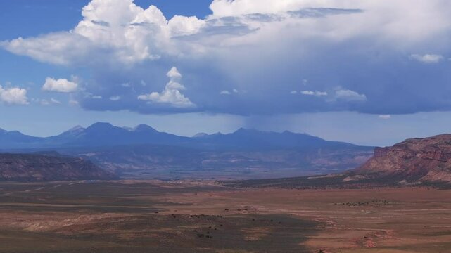 Colorado Utah Border aerial drone circle parallax Moab Spanish Valley La Sal Mountain Rocky Mountains road Telluride Montrose county summer dry Redvale Norwood rain thunderstorm clouds sunny