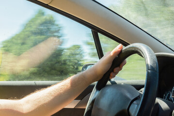 Anonymous man driving through scenic Asturias, view from passenger seat
