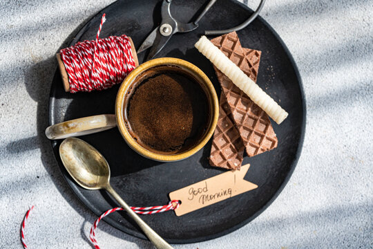 Top view of morning coffee setup with chocolate and waffle