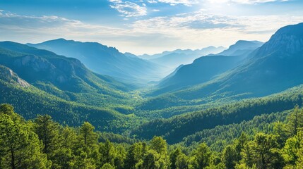 Fototapeta premium Majestic mountain scenery with green forests and a peaceful valley stretching into the distance under a clear blue sky.