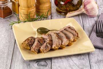 Roasted duck breast slices in the plate