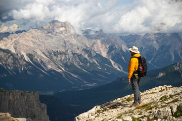 Hiker enjoys the view from Lagazuoi mountain over the italian Dolomites.