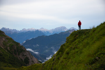 Hiker enjoys the view at Passo Giau in the italian Dolomites. Adventure and travel concept