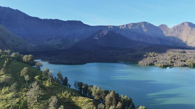Beautiful view of segara anak Lake in the morning, with smooth movement of the drone 4k camera. National Park Rinjani Mountain