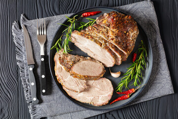 Roast Pork Neck sliced on a plate, top view