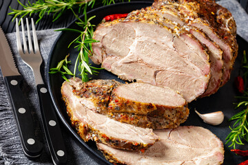Roast Pork Neck sliced on a plate, top view