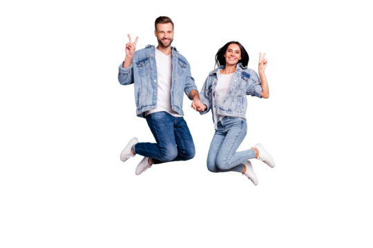 Photo of nice charming cheerful enjoying two people shoiwng you v-sign jumping after having gone on vacation while isolated with blue background