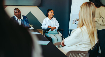 Female student in wheelchair engaging in group discussion promoting equal access and inclusivity in a college classroom setting