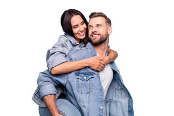 Portrait of charming couple hugging looking wearing denim jeans isolated over blue background