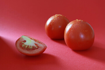 red tomato on the red background