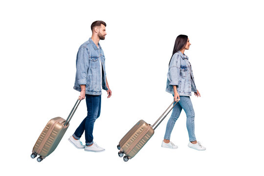 Full length profile side photo of lovely spouses holding trolley wearing denim jeans jackets isolated over blue background