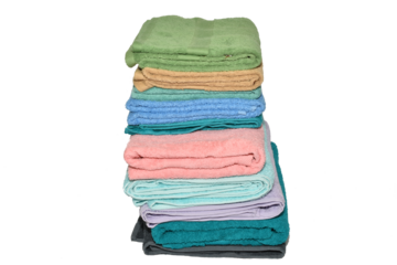 A tall stack of terry towels on a white background.