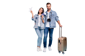 Portrait of charming sweethearts holding pack paper card plane hugging embracing wearing denim jeans jackets isolated over blue background