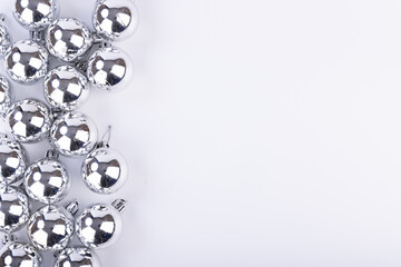 Festive Silver Christmas Decorations on White Table from Above