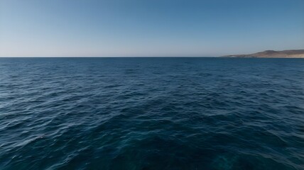 Obraz premium Blue ocean water under a clear blue sky, showcasing crystal-clear water on a warm summer day with tranquil waves