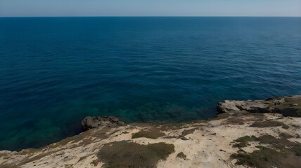 Blue ocean water under a clear blue sky, highlighting crystal-clear water on a beautiful summer day with gentle waves