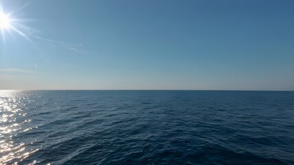 Fototapeta premium Blue ocean water with a clear blue sky, clear water, sea, beautiful summer day with calm waves